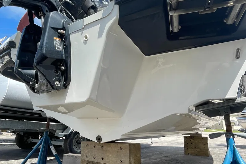 Slide: The Image of 2021 Bayliner VR5 boat hull and outboard motor on blocks for maintenance. - 6