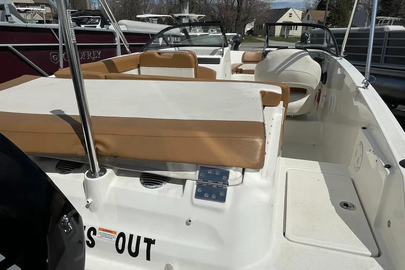 Slide: The Image of 2021 Bayliner VR5 boat interior with tan seating and white deck. - 7