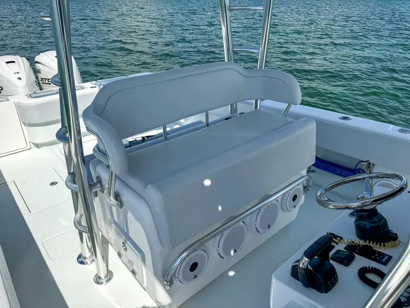 Slide: The Image of 2022 Contender 39 ST boat interior with white seating and steering console. - 12