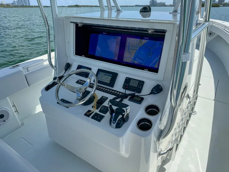 Slide: The Image of 2022 Contender 39 ST boat console with navigation screens and controls. - 14