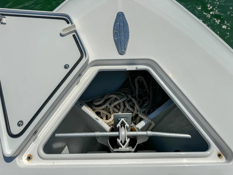 Slide: The Image of Anchor storage compartment on a 2022 Contender 39 ST boat with ropes inside. - 18