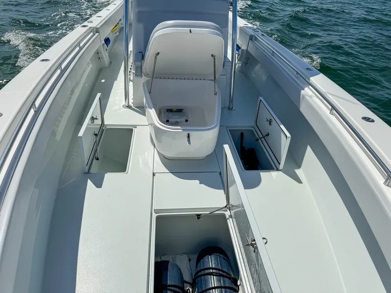 Slide: The Image of 2022 Contender 39 ST boat interior with open storage compartments on the water. - 19