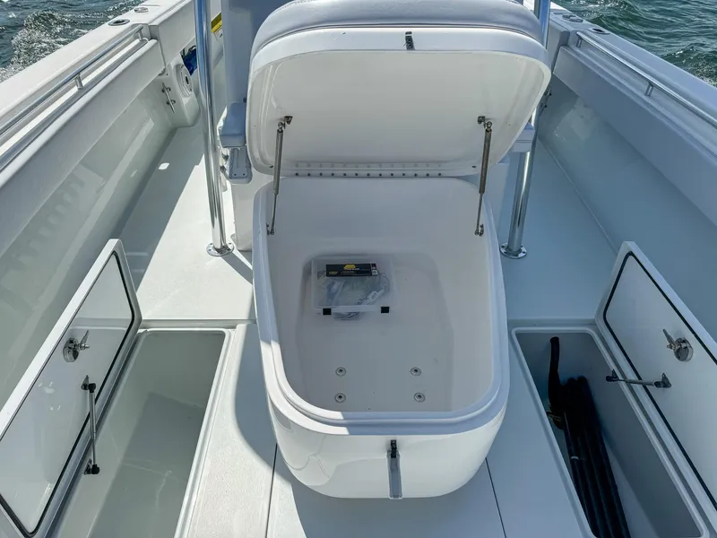 Slide: The Image of 2022 Contender 39 ST boat with open storage compartments. - 21