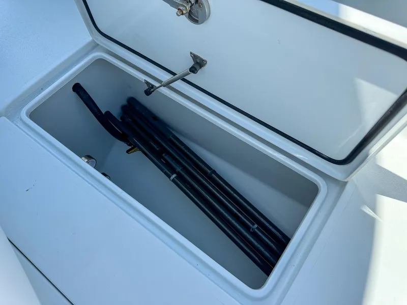 Slide: The Image of Storage compartment of 2022 Contender 39 ST boat with fishing rods. - 23