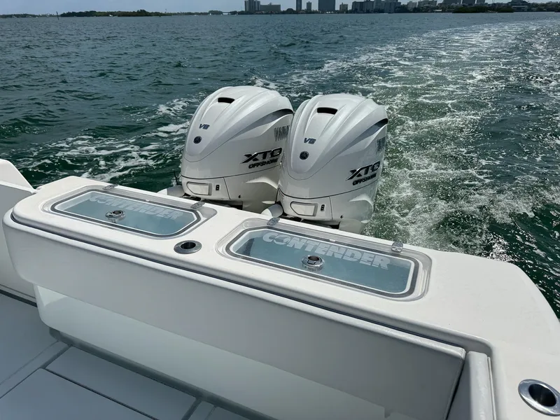 Slide: The Image of 2022 Contender 39 ST boat with twin Yamaha XTO V8 outboard engines on the water. - 24