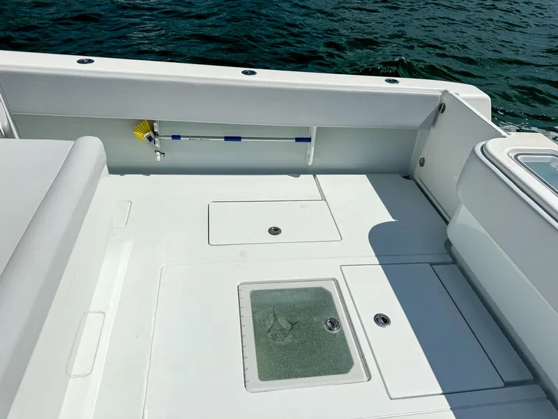 Slide: The Image of 2022 Contender 39 ST boat deck with storage compartments and fishing rod holder. - 25