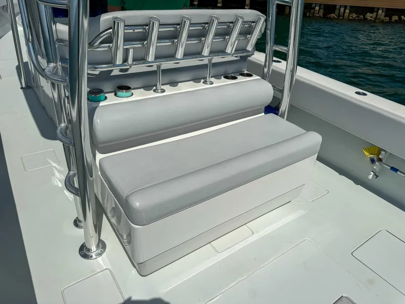 Slide: The Image of 2022 Contender 39 ST boat seating area with rod holders and ocean backdrop. - 26