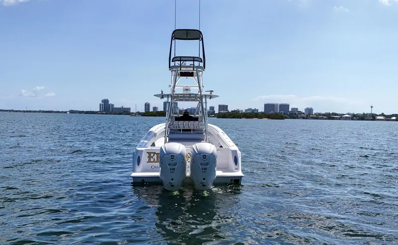Slide: The Image of 2022 Contender 39 ST boat with twin engines on the water, city skyline in the background. - 3