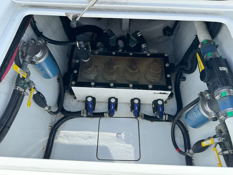 Slide: The Image of 2022 Contender 39 ST engine compartment with fuel filters and hoses. - 31