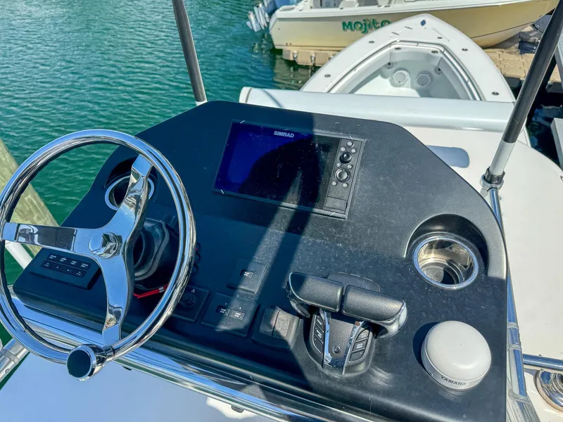 Slide: The Image of 2022 Contender 39 ST boat helm with steering wheel and navigation system. - 36