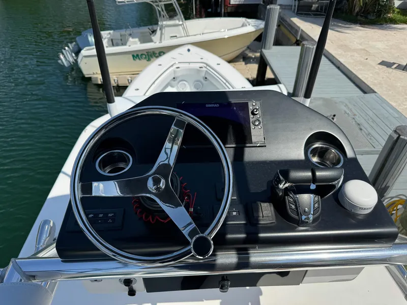 Slide: The Image of 2022 Contender 39 ST boat helm with steering wheel and controls. - 37