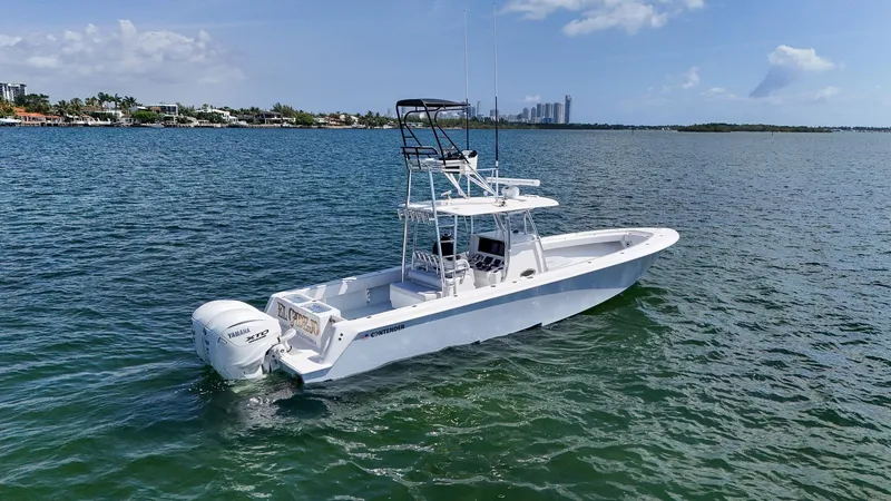 Slide: The Image of 2022 Contender 39 ST boat on open water with city skyline in background. - 45
