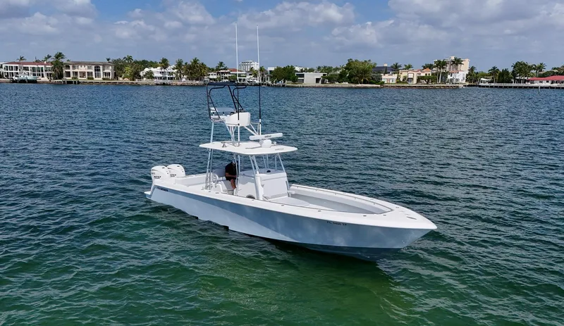 Slide: The Image of 2022 Contender 39 ST boat on calm waters with coastal homes in the background. - 46