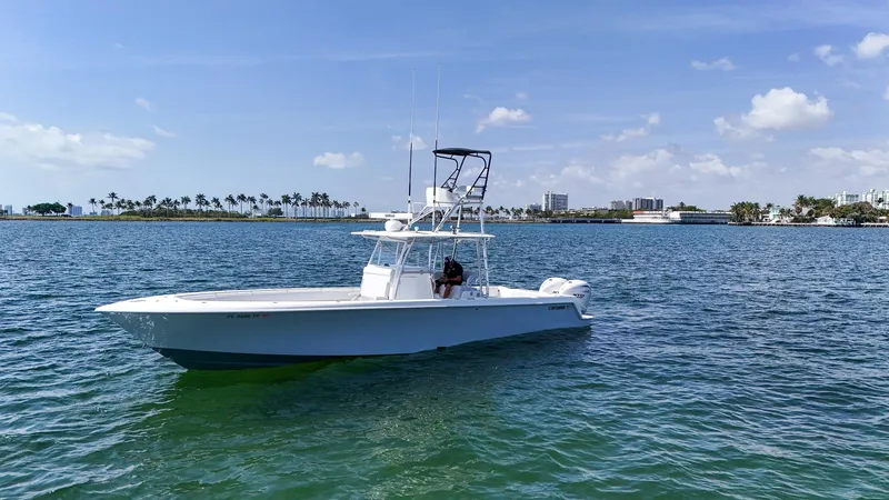 Slide: The Image of 2022 Contender 39 ST boat cruising on a sunny day in calm waters. - 47