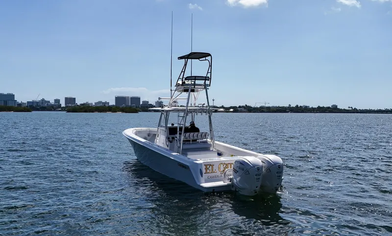Slide: The Image of 2022 Contender 39 ST boat on calm water with city skyline in background. - 49