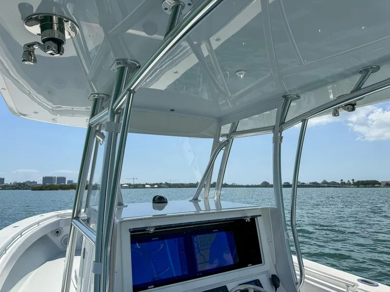 Slide: The Image of 2022 Contender 39 ST boat console with navigation screens on a sunny day. - 8