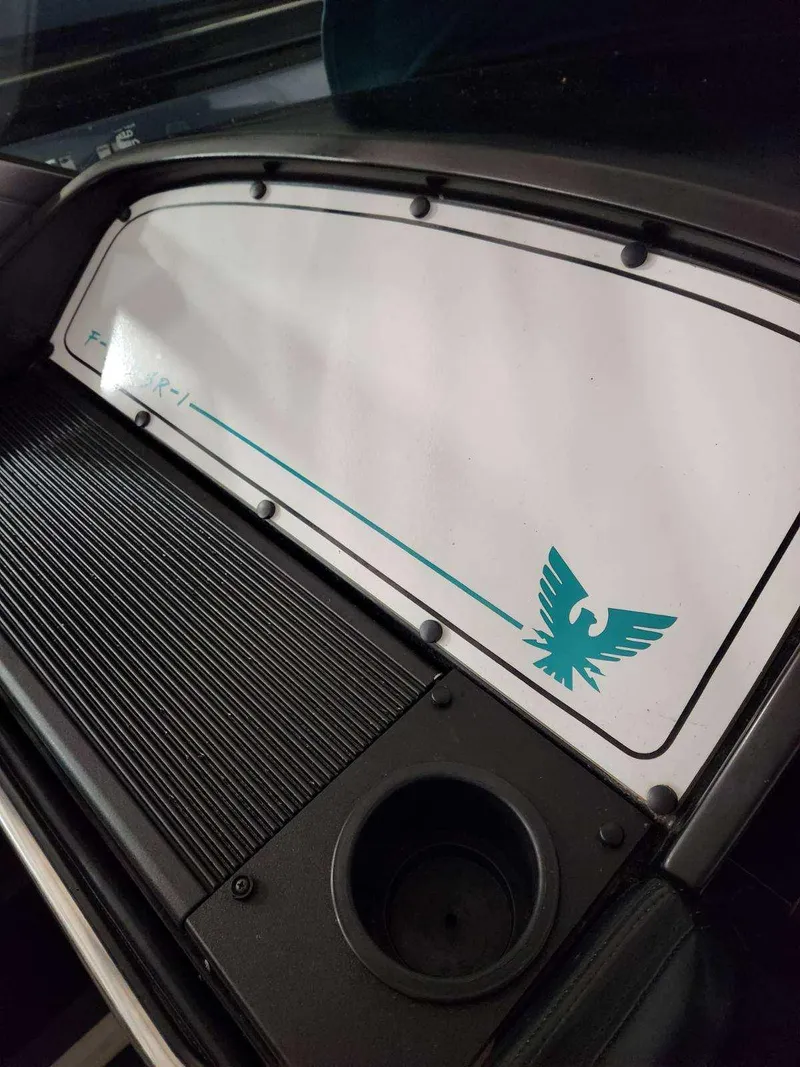 Slide: The Image of 1993 Formula 303 SR1 dashboard with logo and emblem. - 12