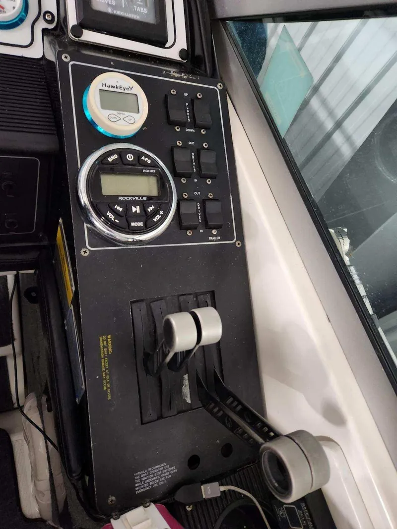 Slide: The Image of Control panel of a 1993 Formula 303 SR1 boat with throttle levers and audio system. - 14