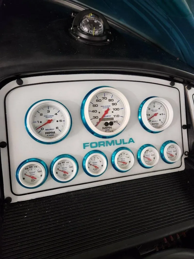Slide: The Image of Dashboard of a 1993 Formula 303 SR1 boat with multiple gauges. - 16