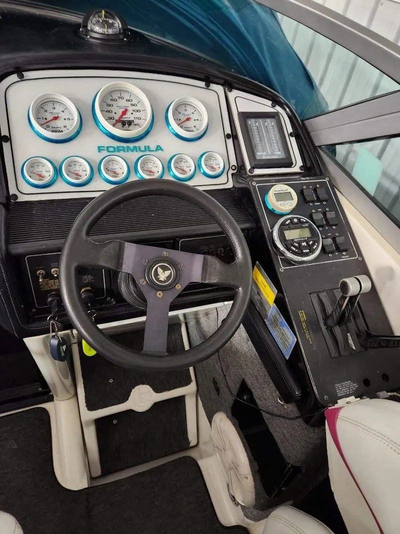 Slide: The Image of 1993 Formula 303 SR1 boat dashboard with steering wheel and gauges. - 17
