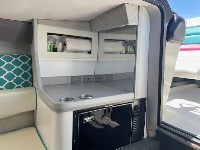 Slide: The Image of Interior of a 1993 Formula 303 SR1 boat with kitchenette and seating area. - 19