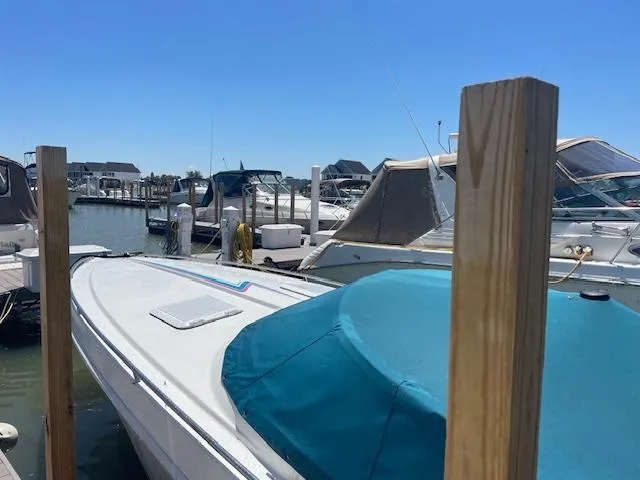 Slide: The Image of 1993 Formula 303 SR1 boat docked at a marina on a sunny day. - 3
