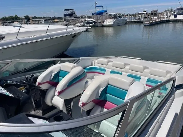 Slide: The Image of 1993 Formula 303 SR1 speedboat docked at a marina with colorful interior seats. - 4