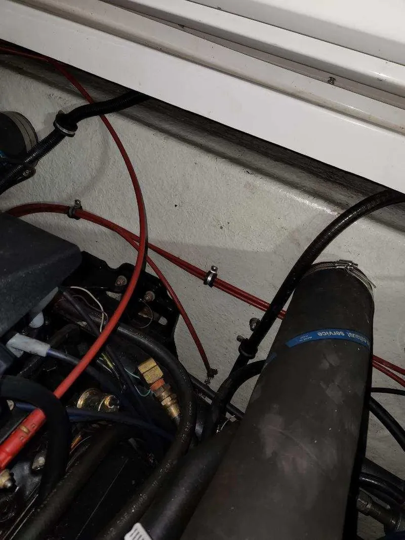 Slide: The Image of Engine compartment of a 1993 Formula 303 SR1 boat with visible wiring and hoses. - 8