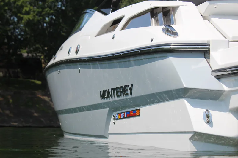 Slide: The Image of 2023 Monterey 298SS boat on water, close-up side view. - 11