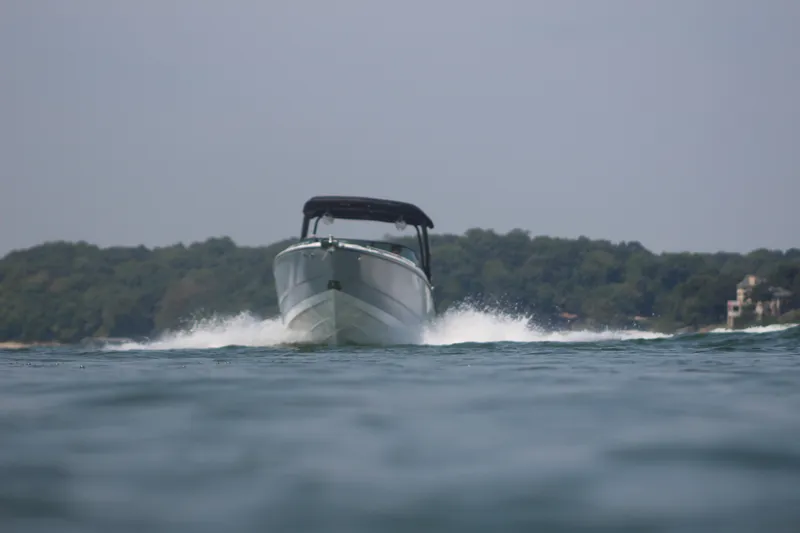 Slide: The Image of 2023 Monterey 298SS boat cruising on a lake. - 18