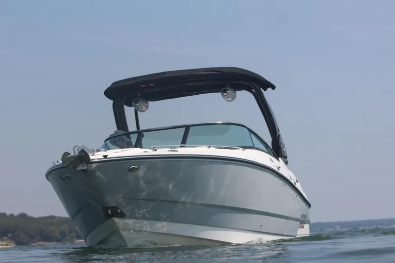 Slide: The Image of 2023 Monterey 298SS boat on water with black canopy. - 21