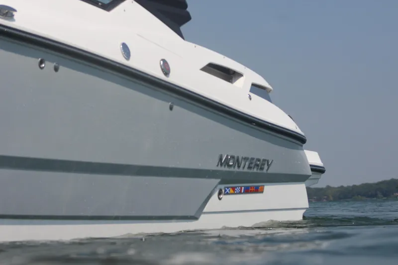 Slide: The Image of 2023 Monterey 298SS boat on water, side view. - 22