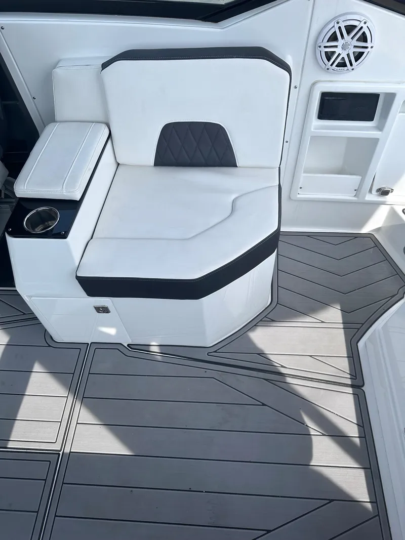Slide: The Image of 2023 Monterey 298SS boat interior with white seating and modern flooring. - 35