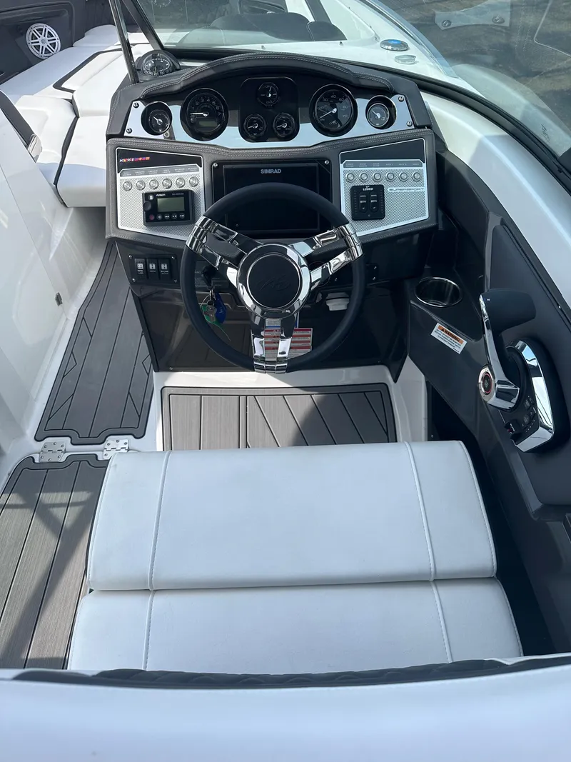 Slide: The Image of 2023 Monterey 298SS boat cockpit with modern steering wheel and control panel. - 39