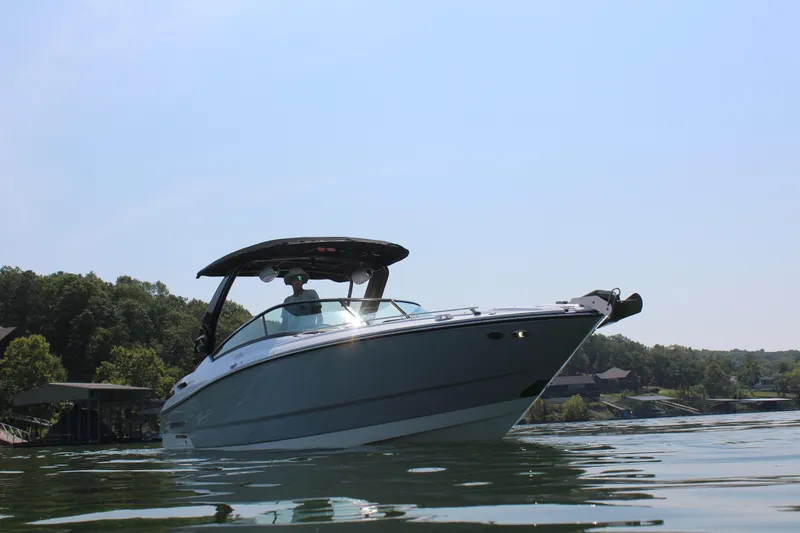 Slide: The Image of 2023 Monterey 298SS boat on a serene lake. - 5