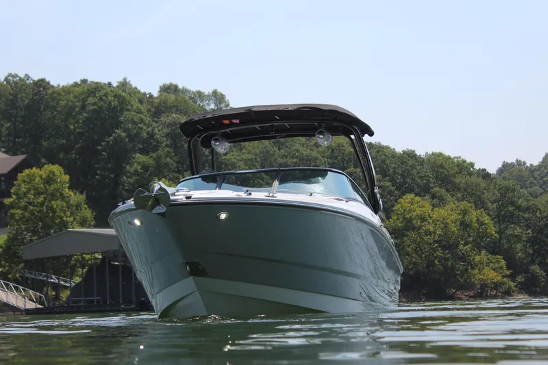 Slide: The Image of 2023 Monterey 298SS boat on a lake near a dock and trees. - 7