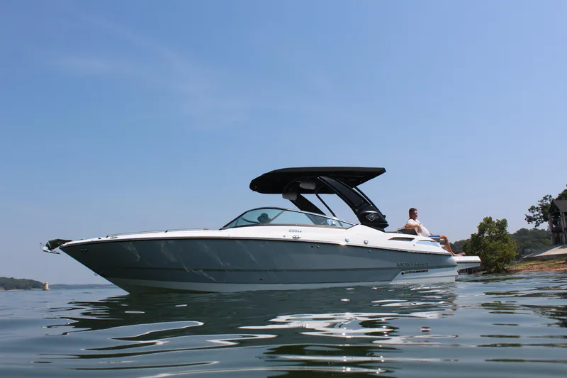 Slide: The Image of 2023 Monterey 298SS boat on calm water with a clear blue sky. - 8