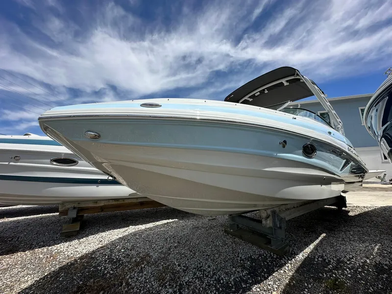 The Image of 2024 Crownline Eclipse E260 XS boat on trailer in showroom. - 1