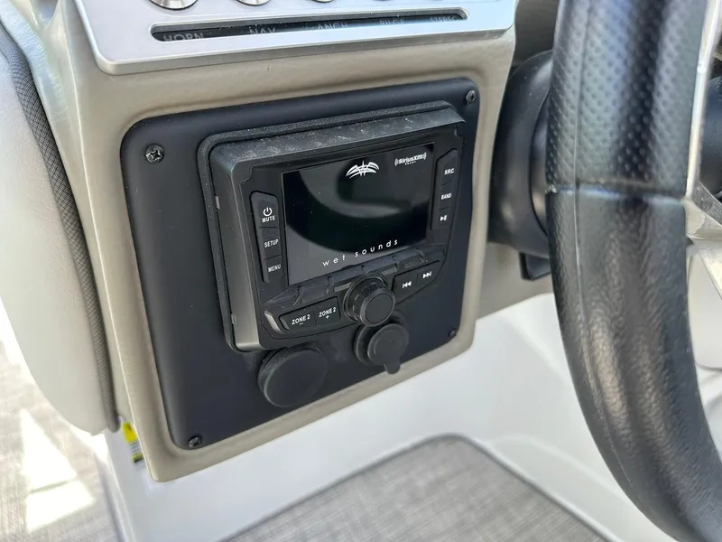 Slide: The Image of 2024 Crownline Eclipse E260 XS boat interior with plush seating and modern design. - 12