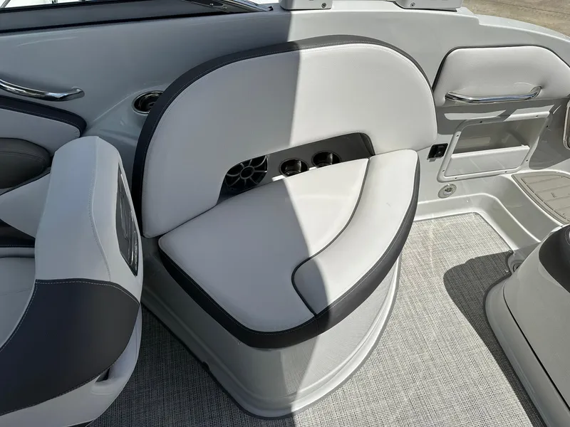 Slide: The Image of 2024 Crownline Eclipse E260 XS boat interior with modern seating and carpeted flooring. - 14