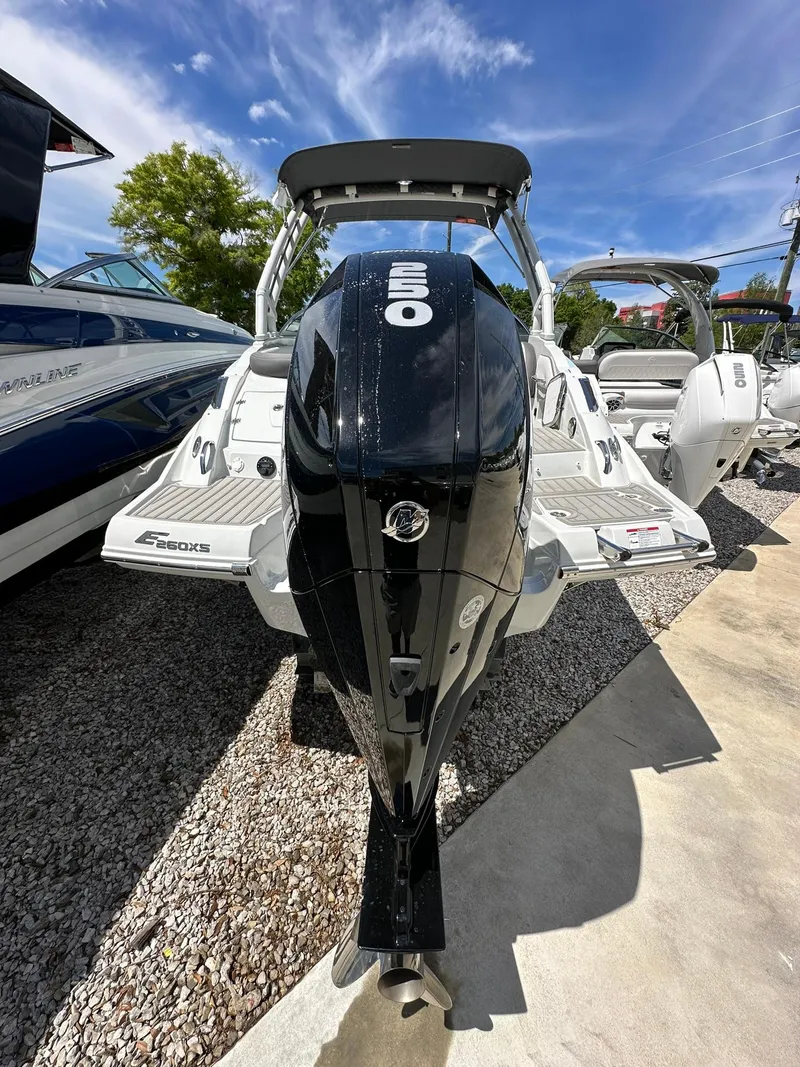 Slide: The Image of 2024 Crownline Eclipse E260 XS boat in showroom, rear view with outboard motor. - 3