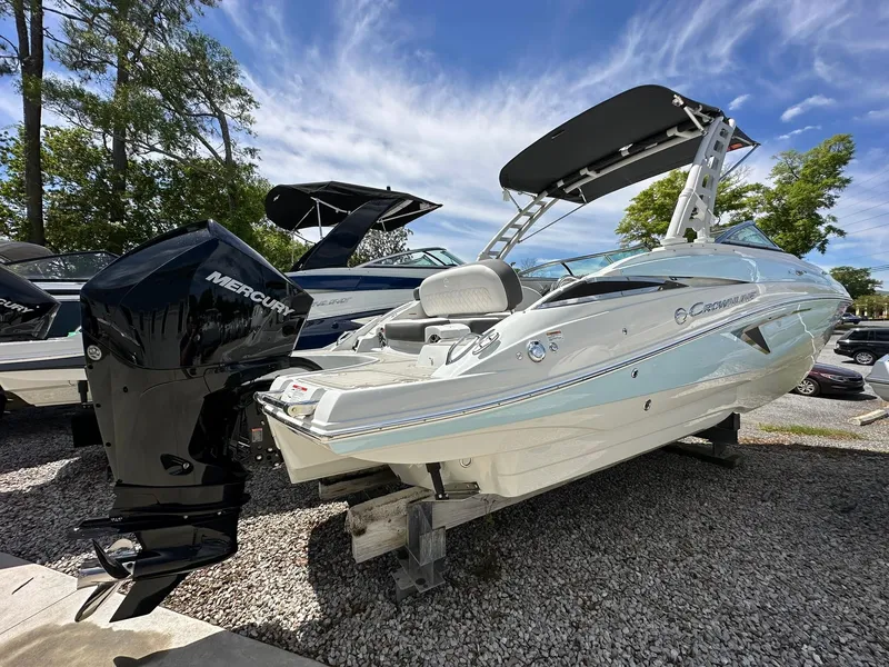 Slide: The Image of 2024 Crownline Eclipse E260 XS boat with powerful outboard motor in showroom. - 4