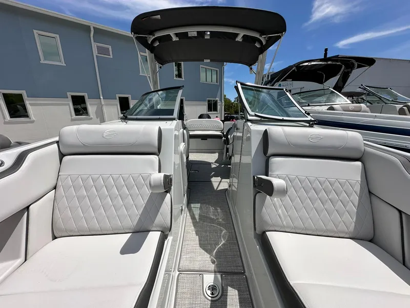 Slide: The Image of 2024 Crownline Eclipse E260 XS boat interior with white cushioned seating. - 7