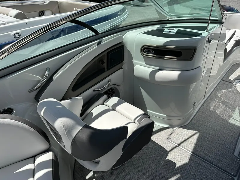 Slide: The Image of 2024 Crownline Eclipse E260 XS boat interior with steering wheel and seating. - 9