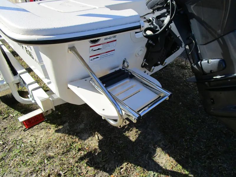 Slide: The Image of 2024 Carolina Skiff E Series E16 JVX CC boat with rear ladder and motor. - 3