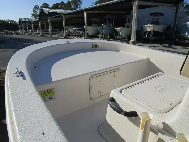 Slide: The Image of 2024 Carolina Skiff E Series E16 JVX CC boat interior, showcasing storage and seating. - 5