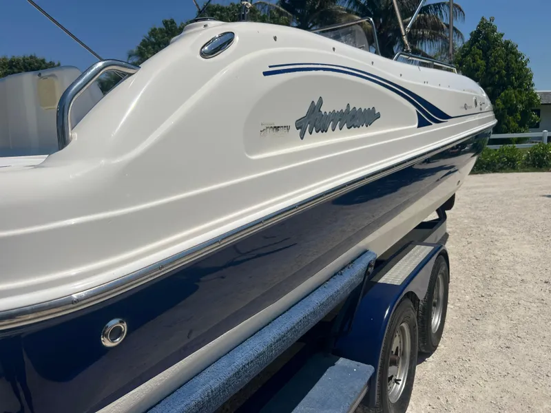 Slide: The Image of 2007 Hurricane 231 boat on trailer, white and blue exterior, side view. - 10