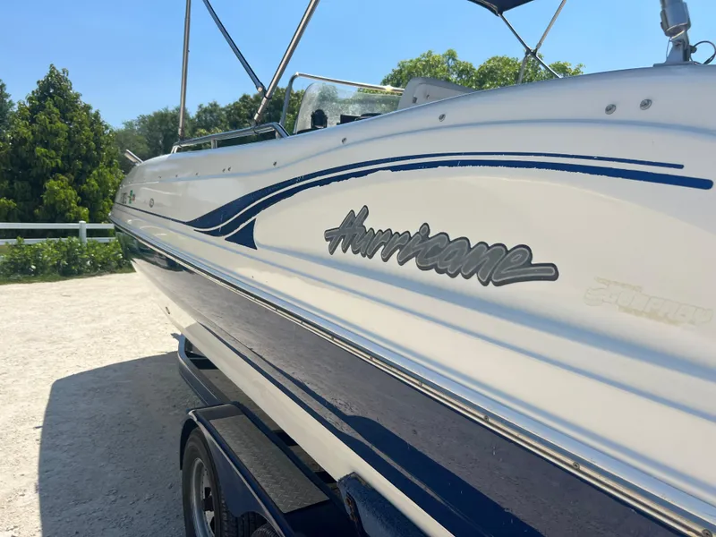 Slide: The Image of 2007 Hurricane 231 boat on a sunny day, side view with logo. - 11