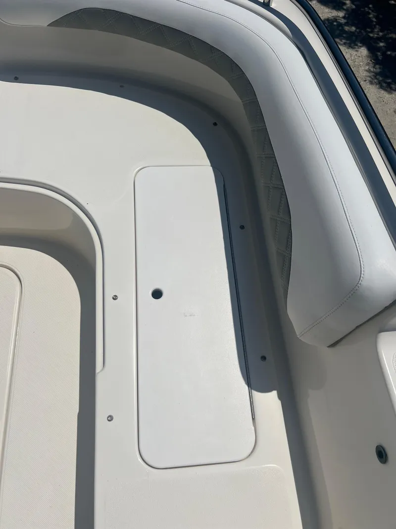 Slide: The Image of 2007 Hurricane 231 boat interior with white cushioned seating. - 20