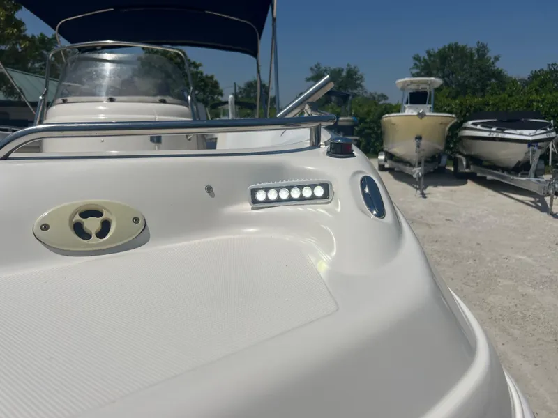Slide: The Image of 2007 Hurricane 231 boat with LED lights and canopy in a marina. - 22